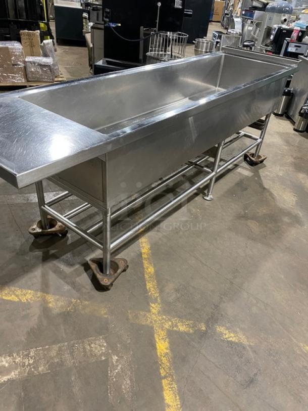 Commercial stainless steel single-well extra-large ice bin with right side drain board, on sturdy legs, excellent condition.