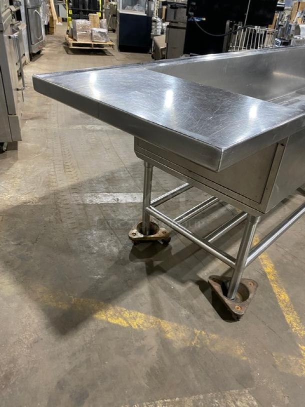 Commercial stainless steel extra-large ice bin with single well, right side drain board, on sturdy legs, in good condition.