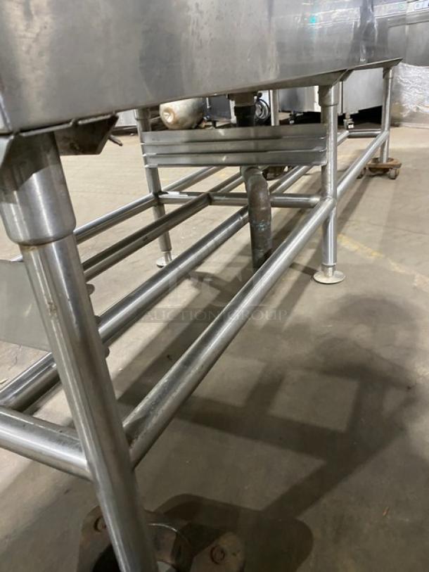 Commercial stainless steel single-well extra-large ice bin with right side drain board, on sturdy legs. Industrial use.