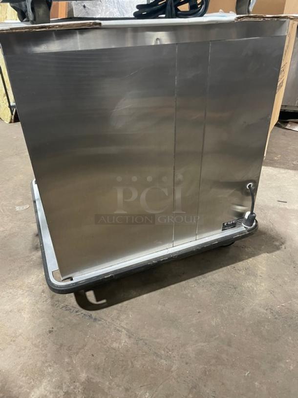 FWE stainless steel undercounter 4-pan heated holding cabinet, Model UHS-4, 120V, on casters, serial number 9428763.