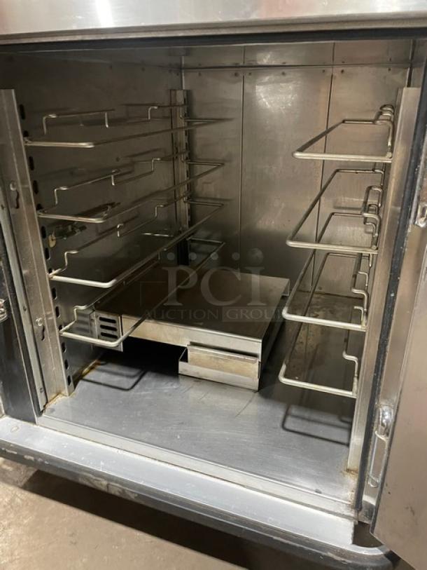 FWE UHS-4 insulated 4-pan heated holding cabinet, stainless steel, electric, 120V, on casters, used condition.