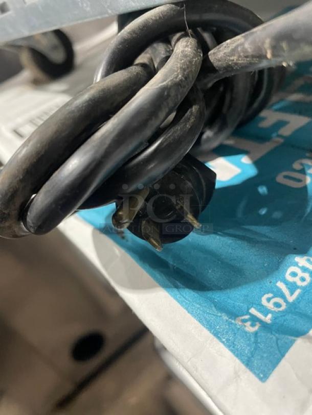 Power cord for Beverage-Air UCR27A refrigerator, 115V, 1 phase, coiled on labeled surface.