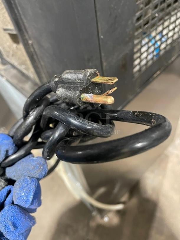 Vero stainless steel electric countertop water dispenser, features drip tray. Auction item, shown with power cord close-up.