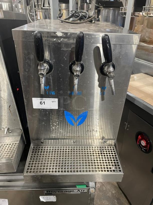 Vero stainless steel electric countertop water dispenser with drip tray, three taps, visible wear, commercial use.