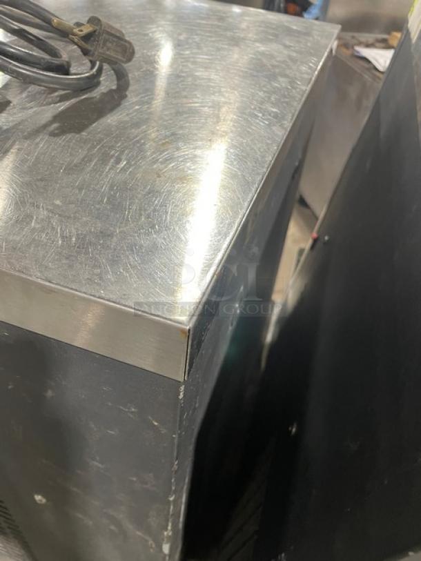 Vero stainless steel electric countertop water dispenser. Visible power cord. Includes drip tray. Surface shows light wear.