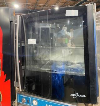 Alto-Shaam commercial stainless steel electric rotisserie oven with digital controls, used. Door marked "Caution Hot!".