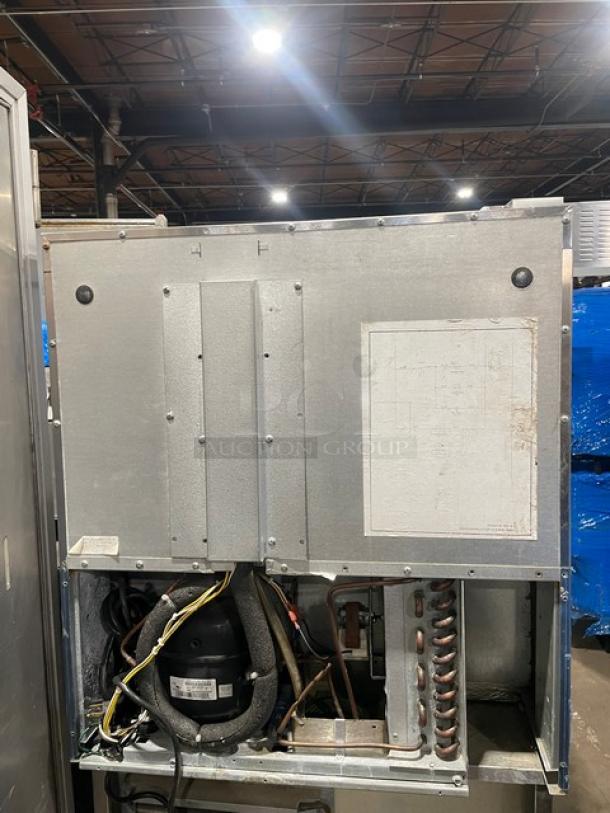 Traulsen UHT27L commercial stainless steel single door undercounter refrigerator with poly coated wire rack, visible wiring and components.