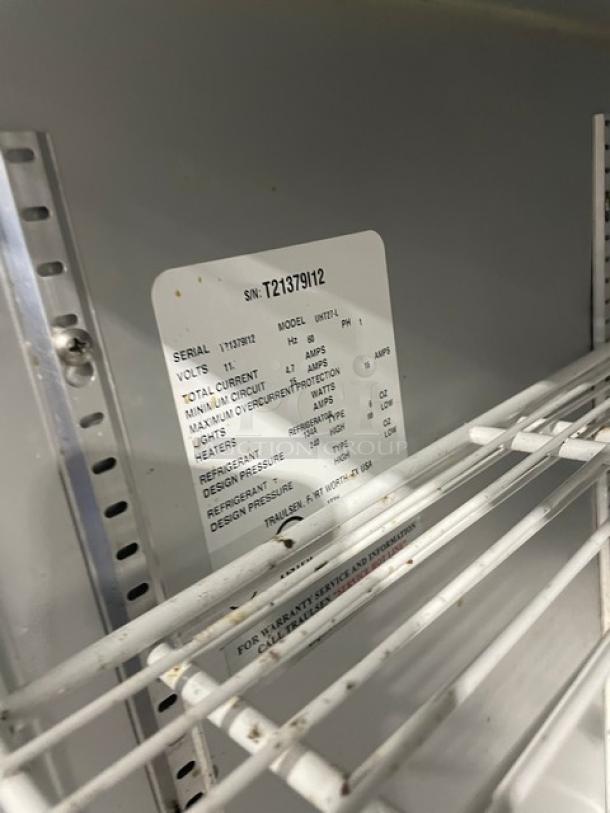 Traulsen UHT27-L stainless steel undercounter refrigerator with poly-coated wired rack. Serial label visible inside.
