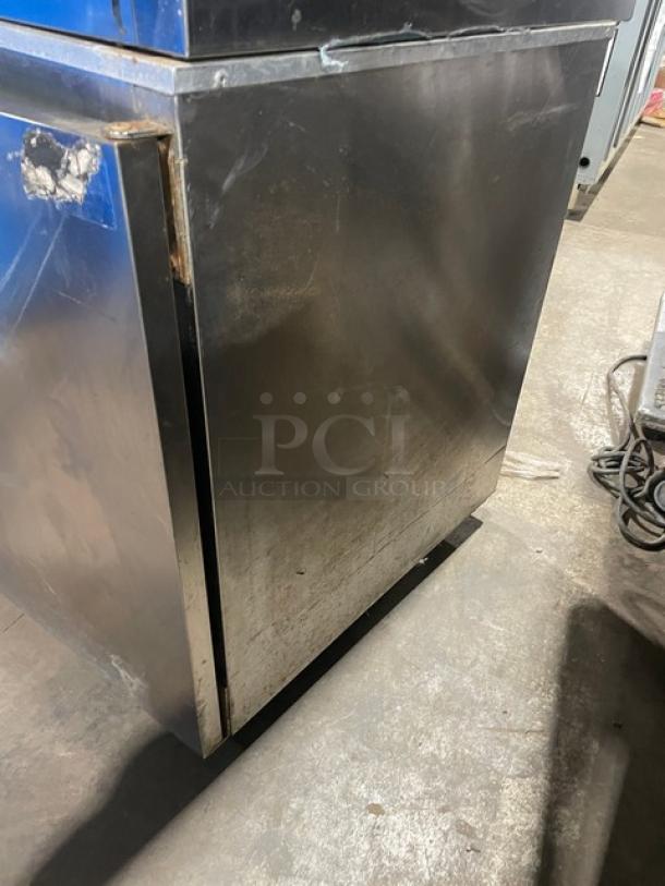 Delfield Model 406CA commercial stainless steel undercounter refrigerator, solid single door, with casters, visible wear.
