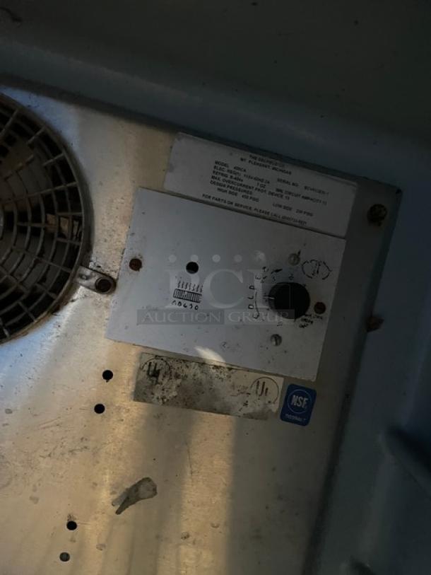 Delfield Model 406CA refrigerator interior with label and temperature dial, NSF certified. Solid single door undercounter fridge.