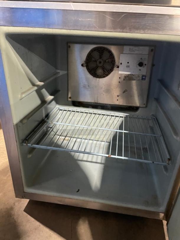 Delfield 406CA stainless steel undercounter refrigerator, single door, poly-coated wire rack, on casters, used condition.