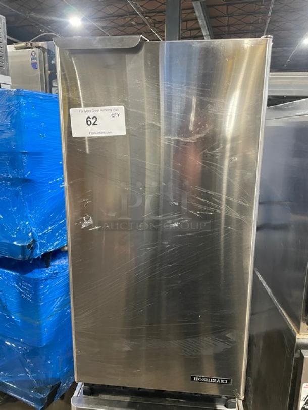 Hoshizaki AM50BAEAD undercounter ice maker, stainless steel, electric powered, model AM-50BAE-AD, visible wear, auction tag showing.