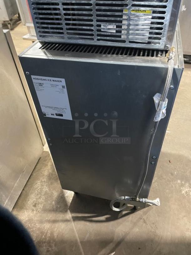 Hoshizaki DCM-270BAH stainless steel ice maker and water dispenser, with drip tray, model label visible, on legs.