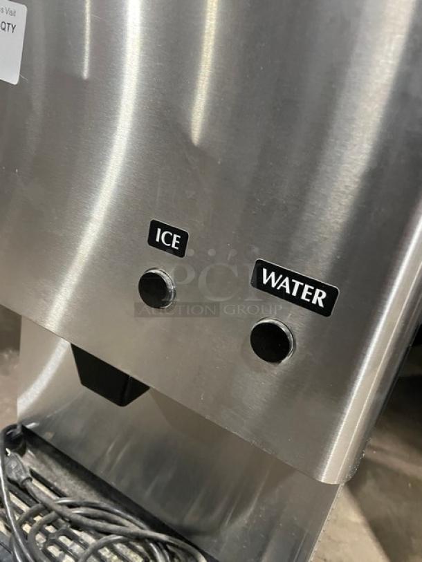 Hoshizaki DCM-270BAH stainless steel ice maker and water dispenser, featuring labeled ice and water buttons, with drip tray.