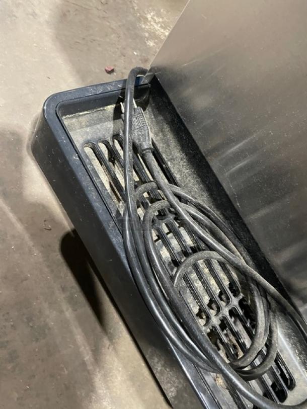 Hoshizaki DCM-270BAH stainless steel ice maker with water dispenser and drip tray. Electric, 115-120V, on legs.