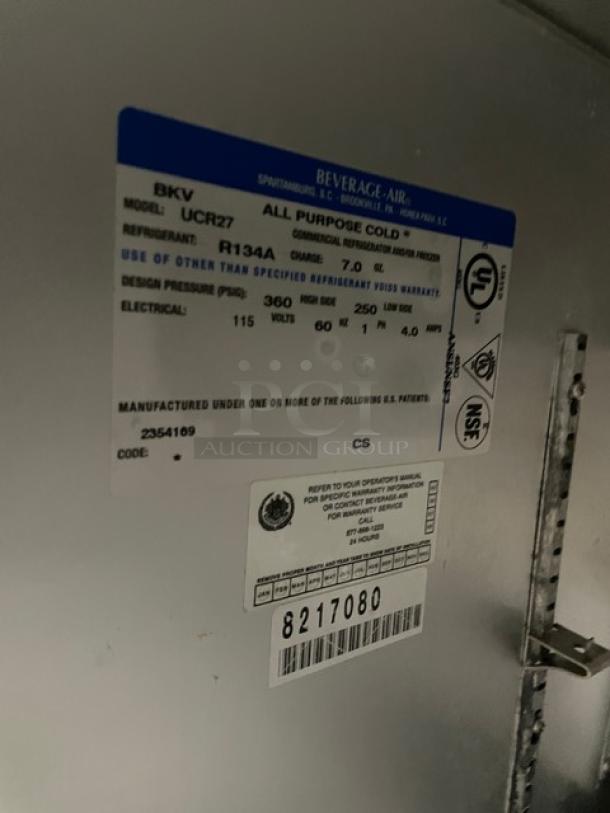 Beverage-Air UCR27A stainless steel undercounter refrigerator, single door, model SN 8217080, with poly coated wire rack, on casters.