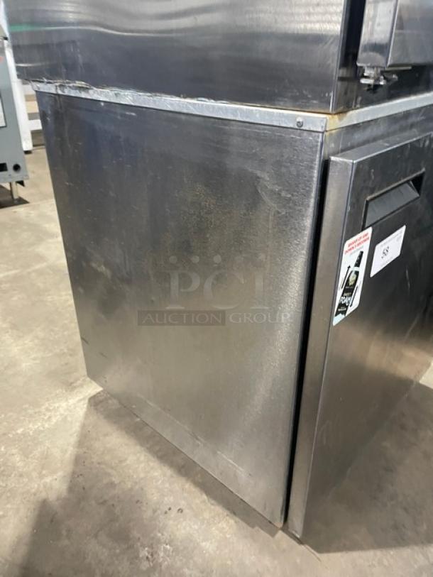 Delfield stainless steel undercounter refrigerator, model 406CA, with poly-coated rack and casters, minor wear visible.