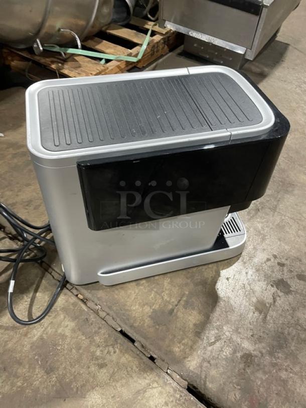 Mars 2025 commercial black electric countertop coffee machine with drip tray, featuring a sleek design, in good condition.