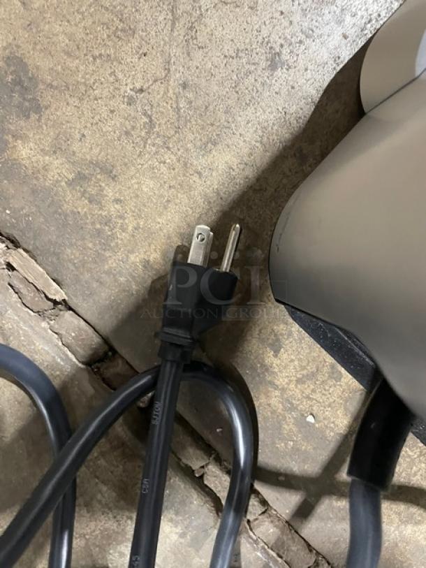 Mars 2025 electric countertop coffee machine power cord detail, showing standard plug.