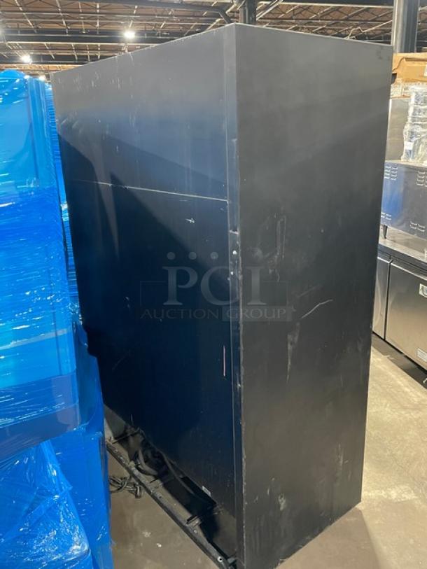 True Commercial Black Double Glass Sliding Door Merchandiser Refrigerator, Model GDM-45. Features poly coated wired rack, 115V, 1 phase. Visible wear on surface.