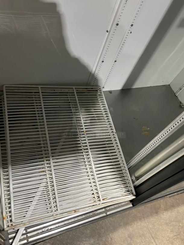 True GDM-45 commercial refrigerator interior with poly coated wired rack, clean condition, for showcasing products.