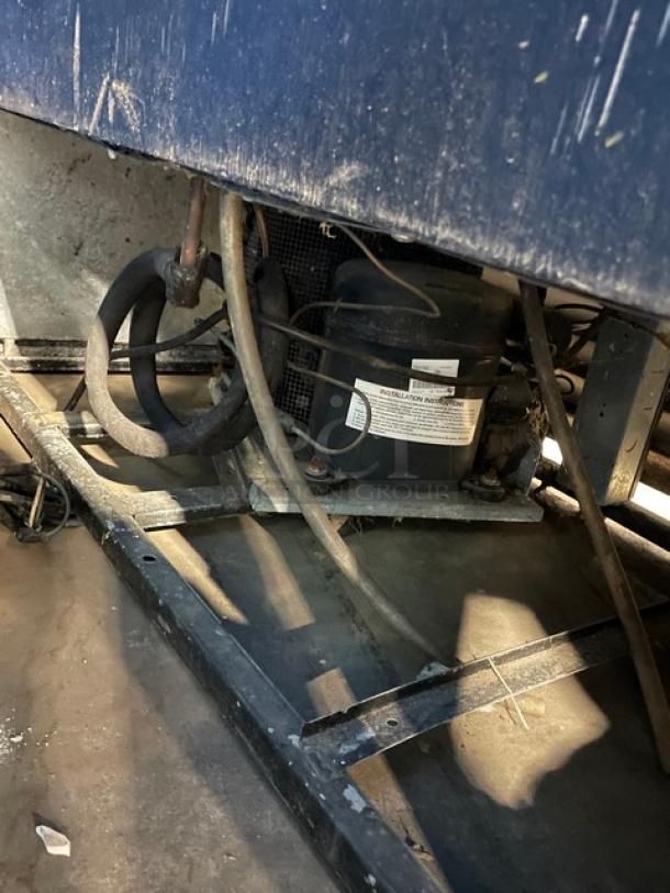 True GDM-45 commercial refrigerator compressor unit, showing wiring and installation label. Model and serial number visible.