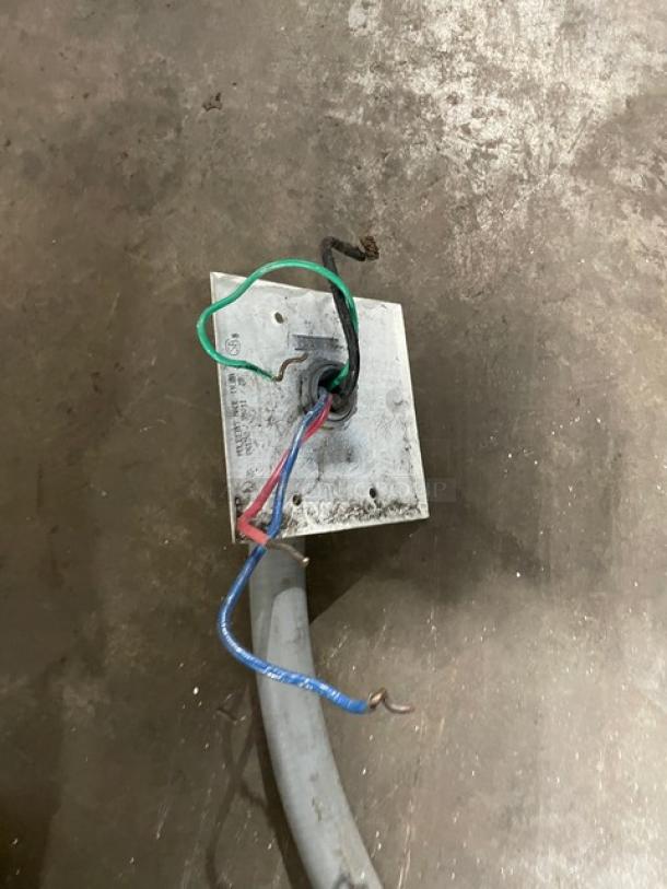 Electric connection for Curtis TP2T16A3100 coffee brewer. Visible wiring and mounting plate on worn floor.