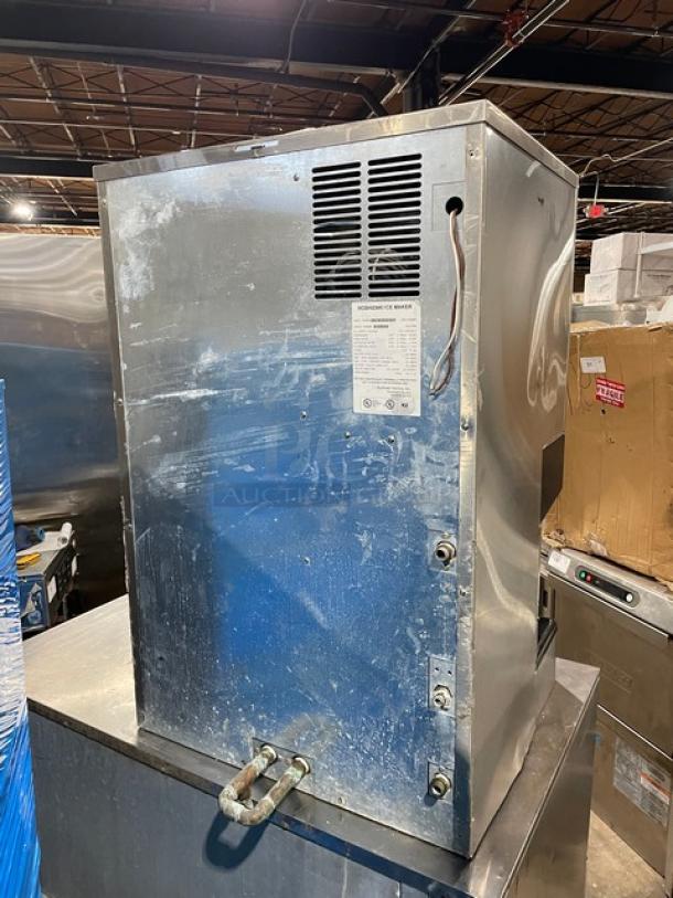 Hoshizaki DCM-500BWF stainless steel ice maker/water dispenser, water-cooled, with drip tray. Shows light wear. Model, specs label visible.