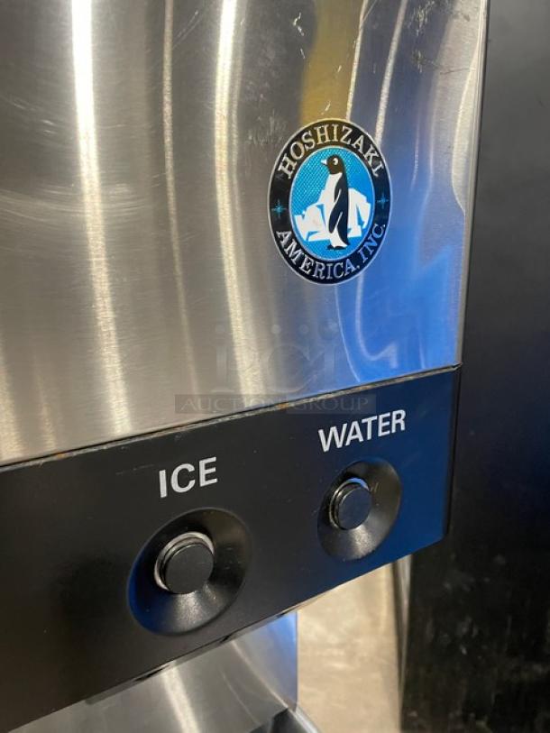 Hoshizaki DCM-500BAF stainless steel ice and water dispenser with drip tray, featuring push buttons and logo, in good condition.