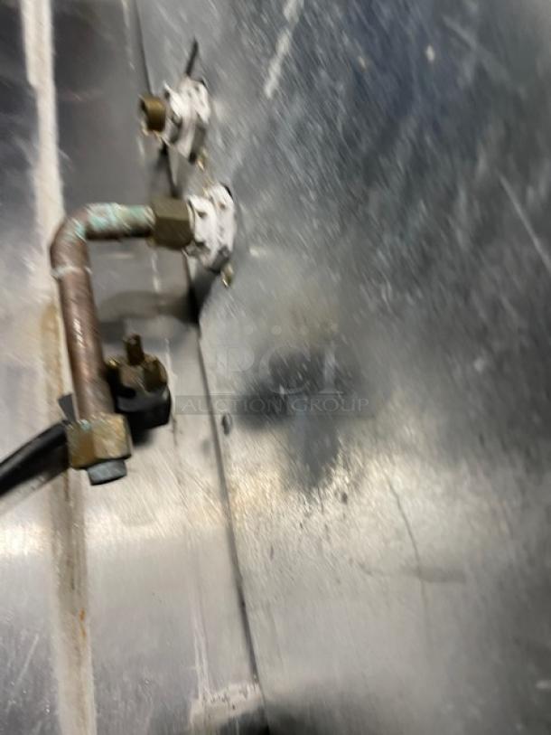 Hoshizaki Model DCM-500BAF stainless steel ice maker/water dispenser, showing connection details and piping, used condition.