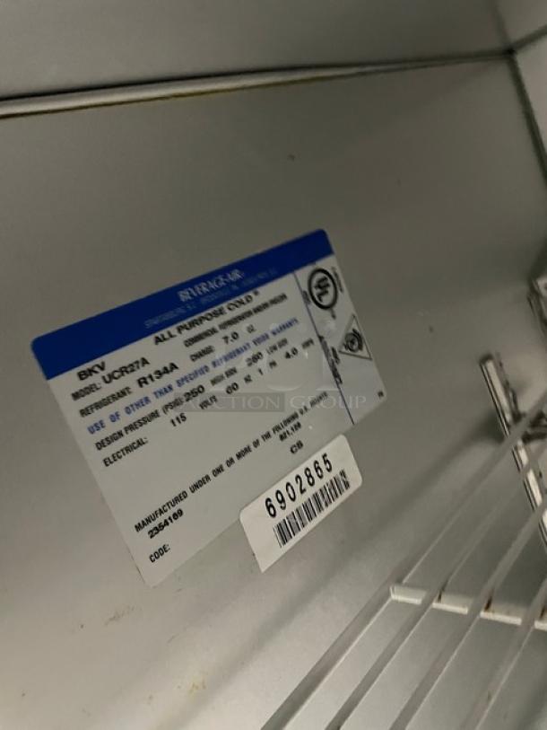 Beverage-Air UCR27A stainless steel undercounter refrigerator, single door, poly-coated wire rack, model number and serial label visible.