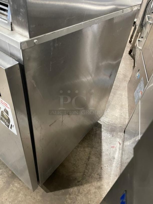 Delfield stainless steel single door undercounter refrigerator, model 406CADHLDD1, with casters and poly coated wired rack.