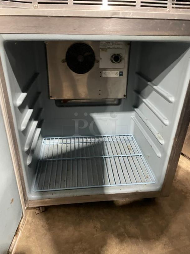 Delfield single door undercounter refrigerator, model 406CADHLDD1, stainless steel, poly-coated wire rack, on casters.