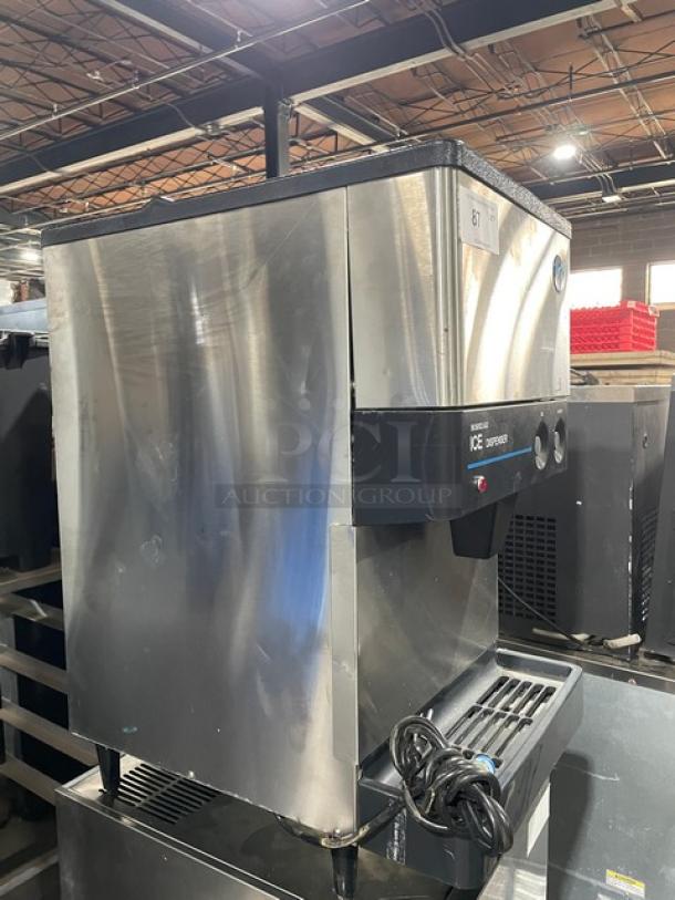 Hoshizaki DCM-270BAH stainless steel ice/water dispenser, air-cooled, electric, with drip tray, on legs, model label visible.