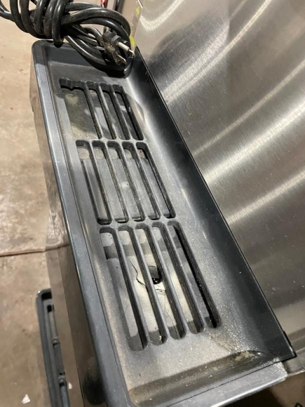 Hoshizaki DCM-270BAH stainless steel ice/water dispensing machine with drip tray, electric-powered, air-cooled, on legs.