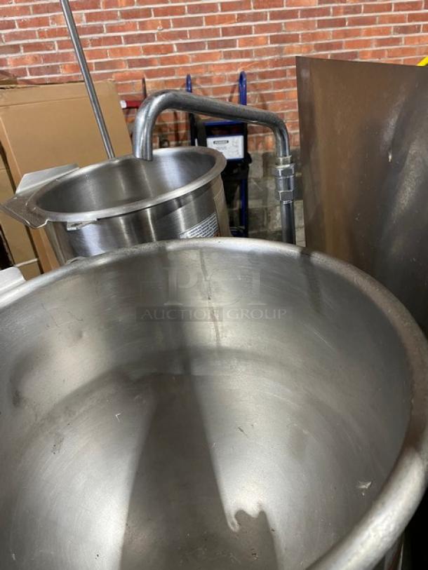 Market Forge stainless steel double tilting soup kettle, natural gas powered, self-contained, on legs, used condition.