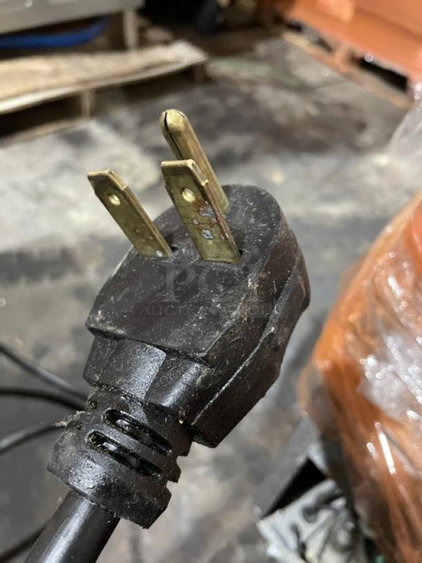 Close-up of an electrical plug for a MerryChef 402S rapid cook oven, showing a 208V three-prong configuration.