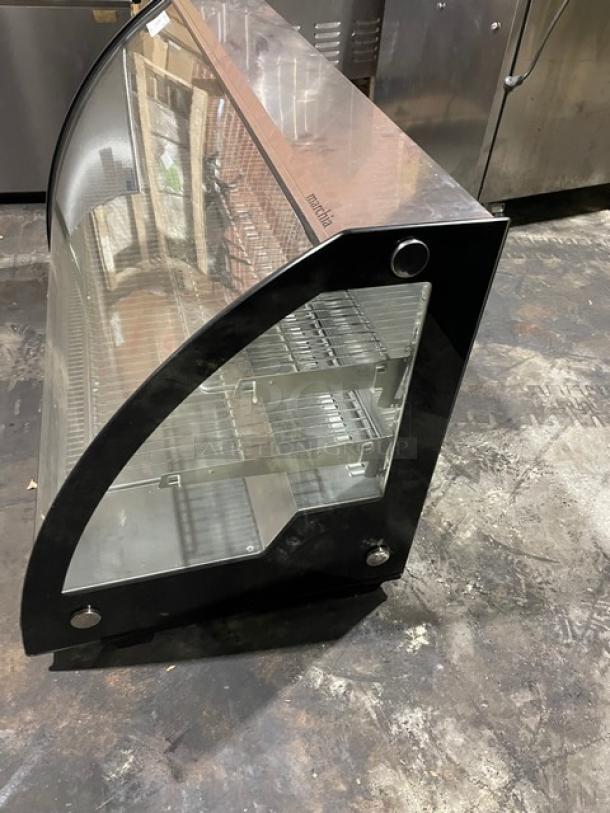 Marchia MDC201 black curved glass 48" refrigerated bakery display case, multi-tiered with wired rack, excellent condition.