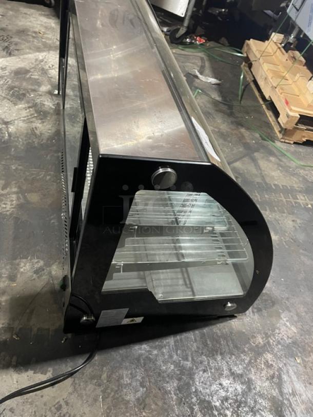 Marchia black curved glass 48" refrigerated display case, model MDC201. Features multi-tier wired racks, commercial use.