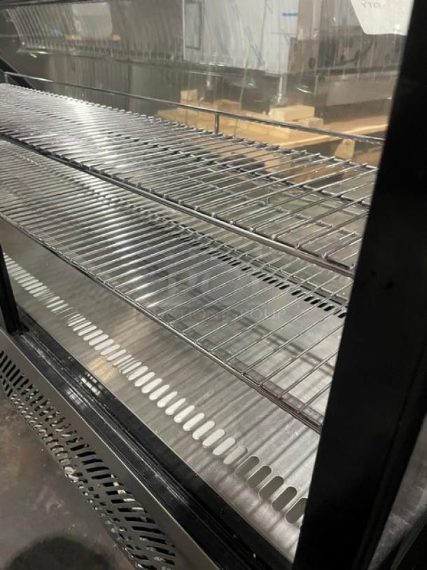 Marchia curved glass 48" refrigerated bakery display case, model MDC201, black finish, wire rack shelves, excellent condition.