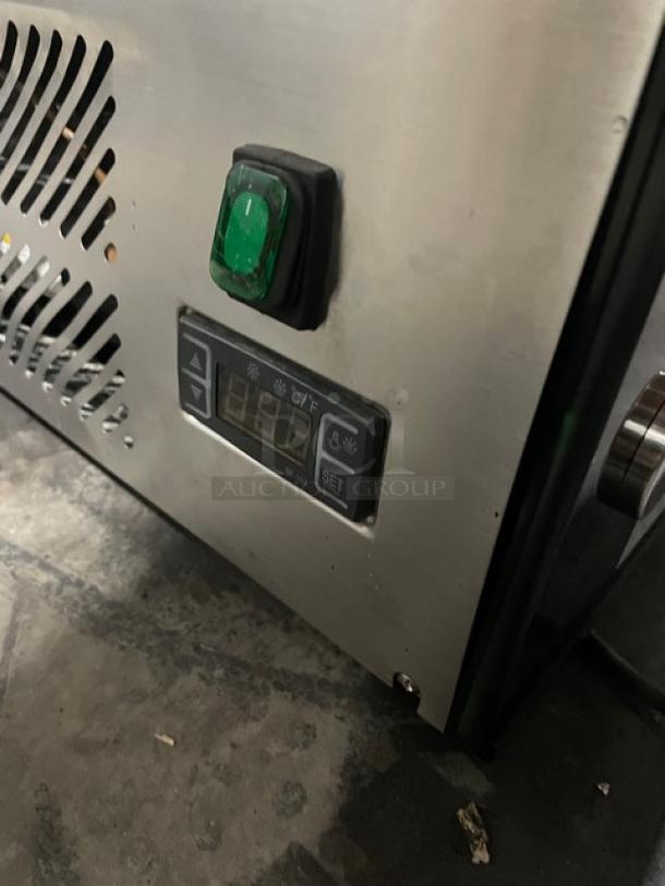 Marchia MDC201 control panel with temperature display and green power switch, on a multi-tier refrigerated bakery display case.