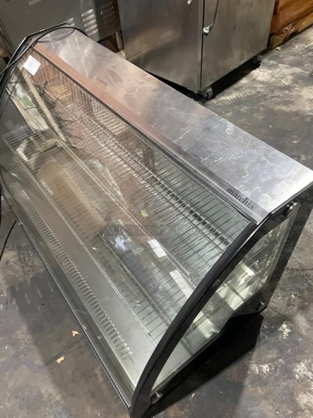 Marchia MDC201 48" curved glass refrigerated bakery display case. Features multi-tier wired racks, excellent condition.