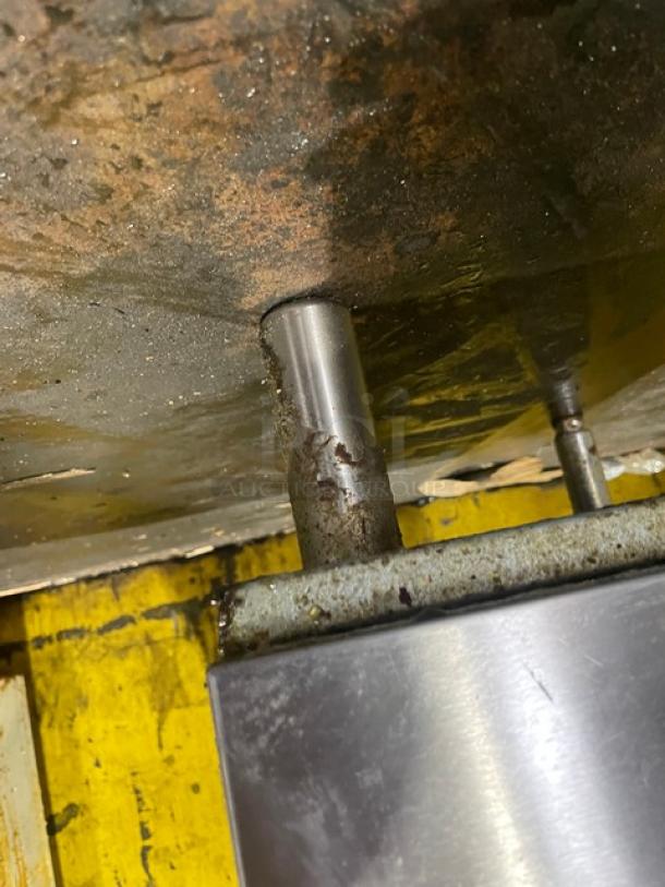 Close-up of the Vulcan Veg Series stainless steel fryer leg, showing some rust and wear on the mounting area. Model: 1VEG50M-1.