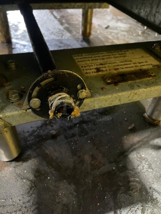 Vulcan Veg Series fryer bottom view, stainless steel, Model 1VEG50M1, showing legs and piping with visible wear.