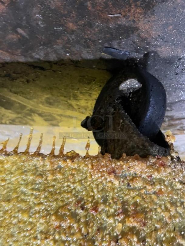 Frymaster PMJ135SD fryer wheel, slightly worn, attached to fryer base, functional when removed.