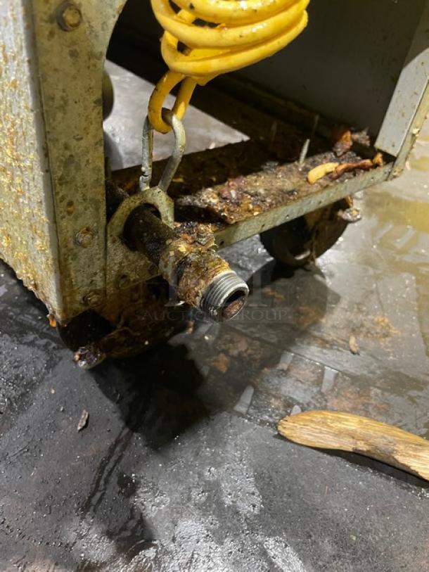 Frymaster PMJ135SD commercial fryer on casters, showing rusted connection and debris on base. Used condition.