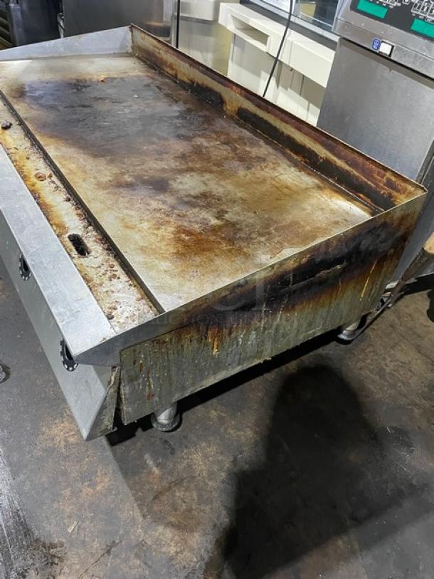 Star Ultra Max Series stainless steel flat griddle, natural gas powered, on legs, used condition with visible rust and wear.