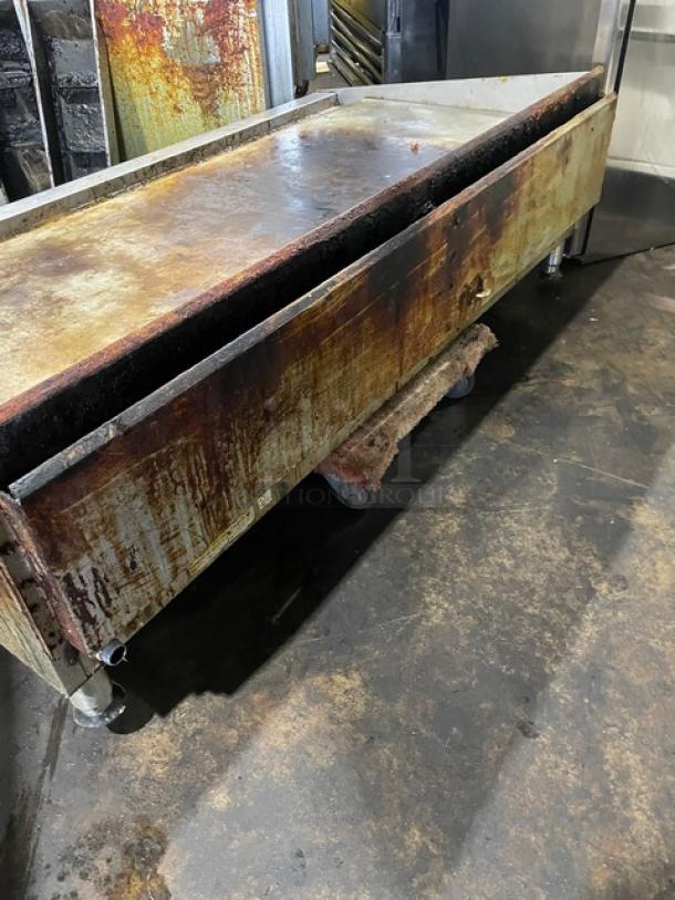 Star Ultra Max Series stainless steel flat griddle, natural gas, commercial-grade, mounted on legs, well-used condition.