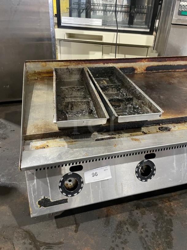 Star Ultra Max Series commercial stainless steel flat griddle, natural gas-powered, shows signs of wear, set on legs.