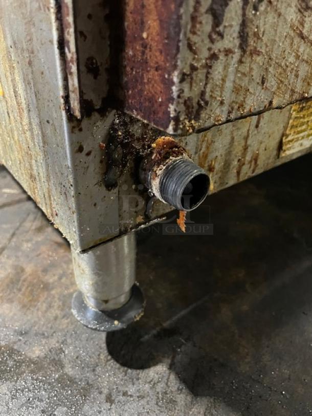 Star Ultra Max Series commercial flat griddle corner view, showing stainless steel construction on adjustable legs, with visible wear and rust.